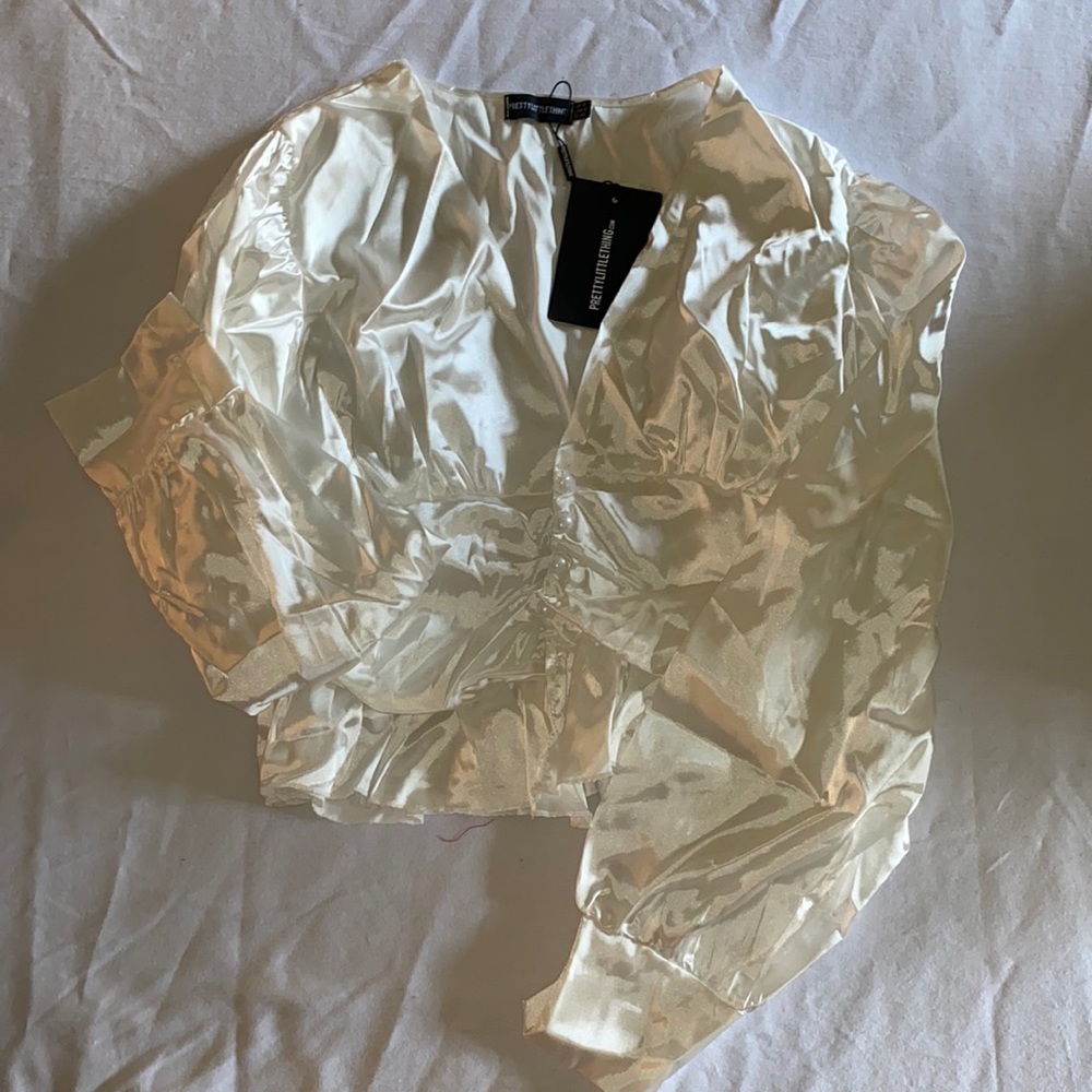 White satin button waist blouse.